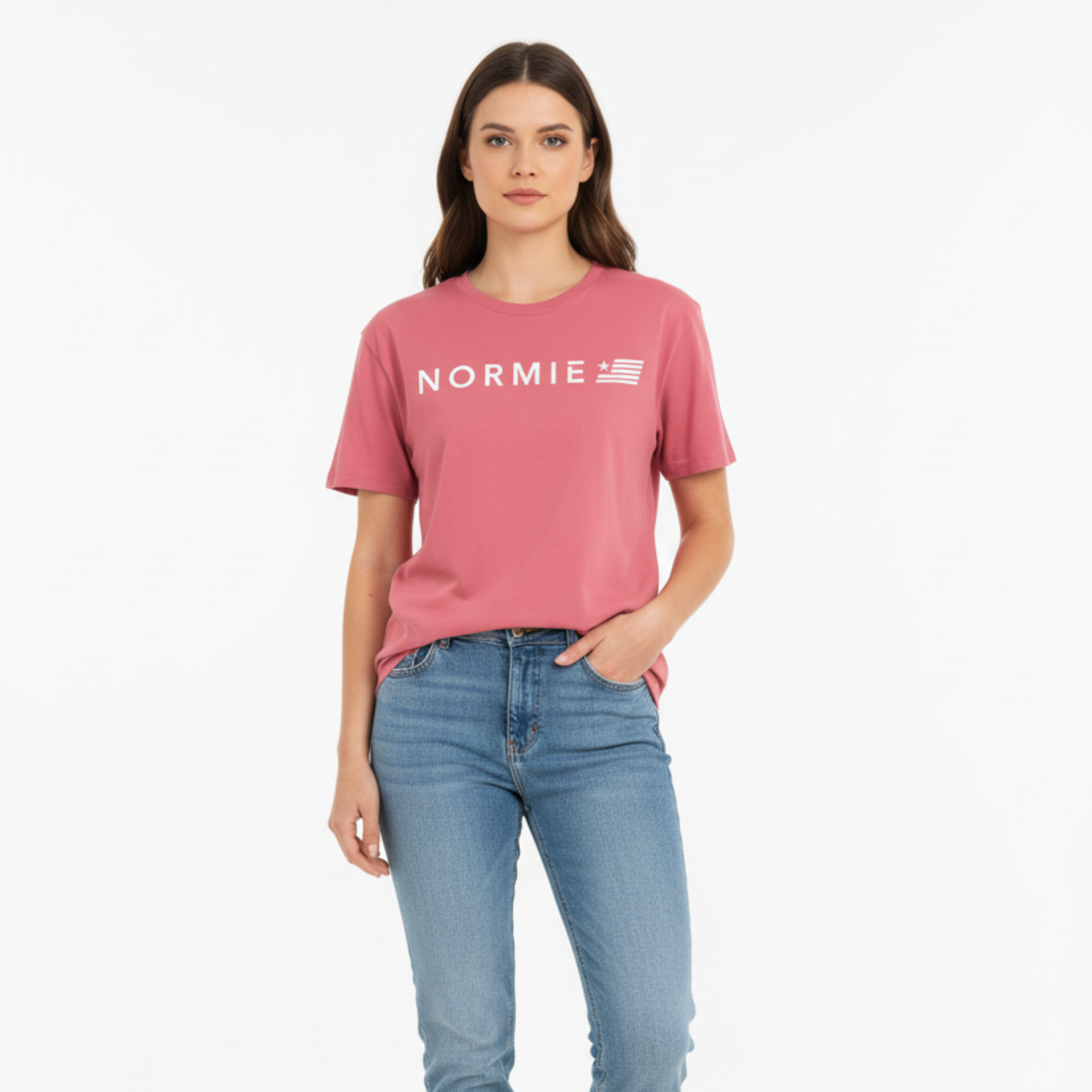Woman wearing a pinkish red 'NORMIE' t-shirt and blue jeans on a white background