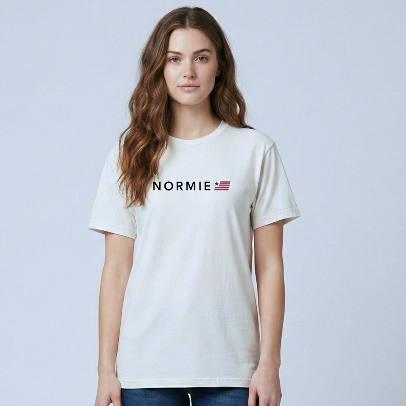 Woman wearing a white t-shirt with 'NORMIE' logo on a light gray background