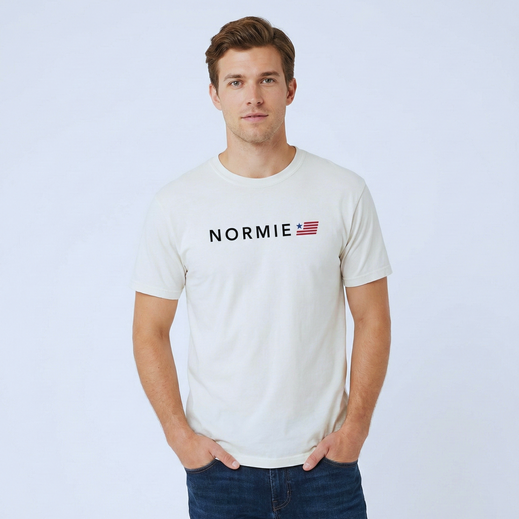 Man wearing a white t-shirt with 'NORMIE' logo on a light blue background