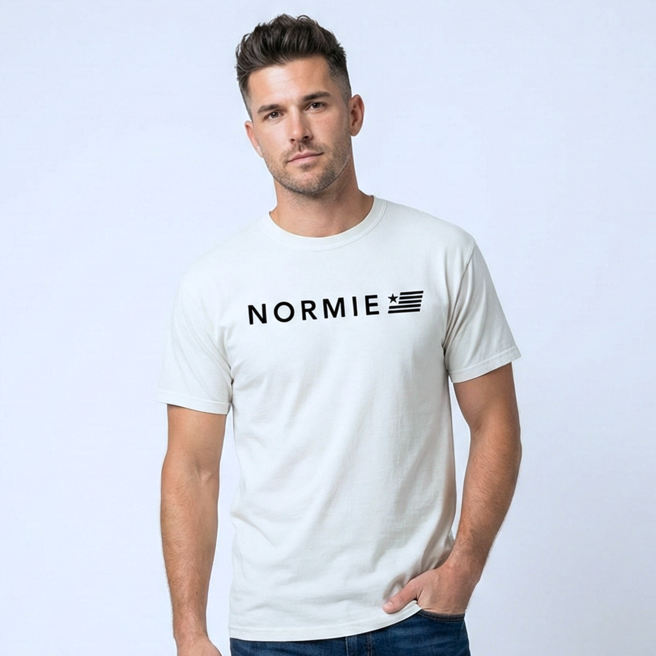 Man wearing a white t-shirt with 'NORMIE' logo on a light gray background